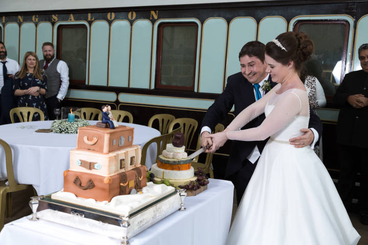 Bride and groom cutting the cake at Bucks Railway Centre wedding venue. Photography and videography 