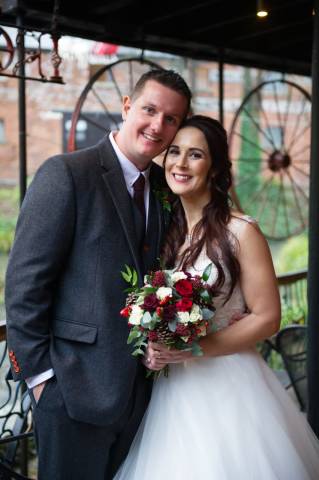 Bride and groom on their wedding day taking photos within the grounds of Egypt Mill