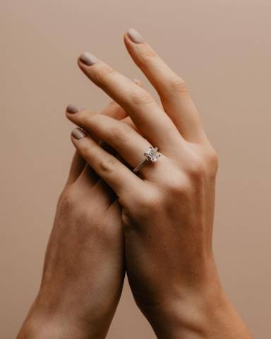 Alluring emerald cut diamond Nouveau ring, with luxurious, hand-finished grain, diamond-set shoulders