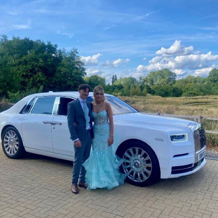 couple in front of rolls royce