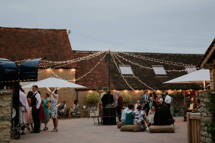 Courtyard of Stratton Court Barn Venues in Oxfordshire with fairylights and food van