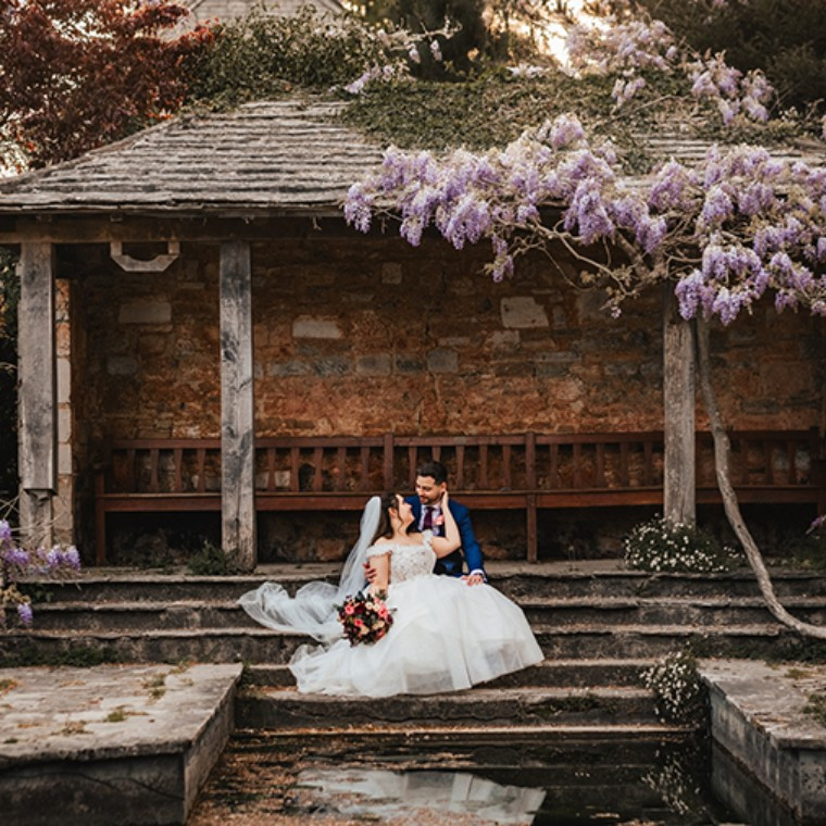 Kingston Maurward Bride and Groom under wistaria