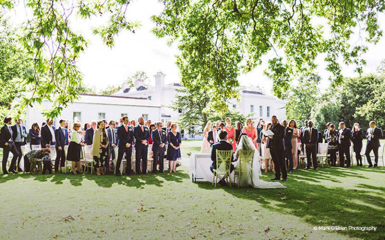 A couple celebrate their ceremony in the stunning gardens at Morden Hall