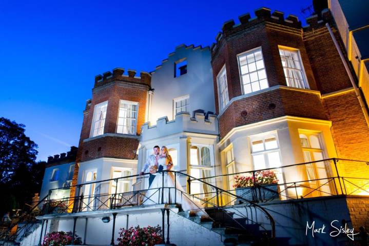 Taplow house newlyweds pose for a picture at dusk