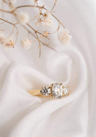 The Tessa trilogy ring is a beautifully elegant style, featuring an oval centre stone with two round brilliants.