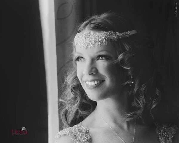 Bride looks out of the window in deep thought