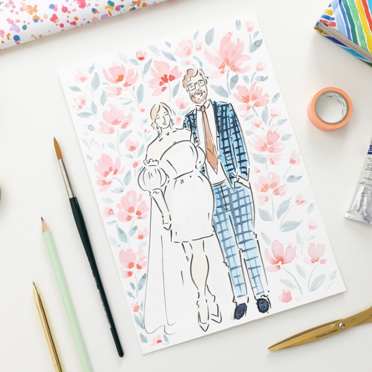 Photo of an illustrated bride and groom, surrounded by pink painted flowers.  The bride is wearing a short white dress with puff skeeves and a veil and the groom is wearing a blue check suit.