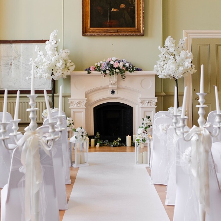A beautiful ceremony aisle decorated with luxury artificial flowers.  