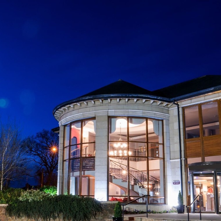 Glassed windowed front of Seagoe Hotel at nighttime.