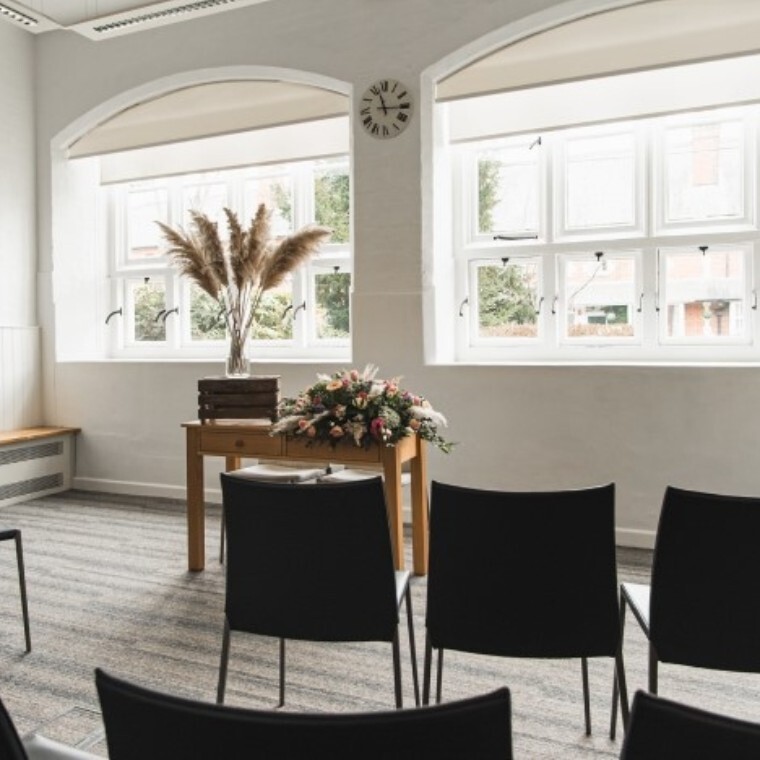 White room with big windows and grey carpet