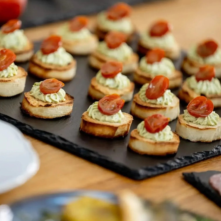 Wedding canapés served on slate platters by Fables Catering & Events