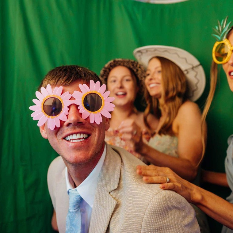 Colourful, fun wedding guests in photobooth