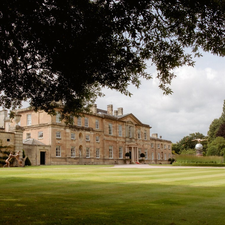 A photo of a Georgian Wedding Venue with a long driveway