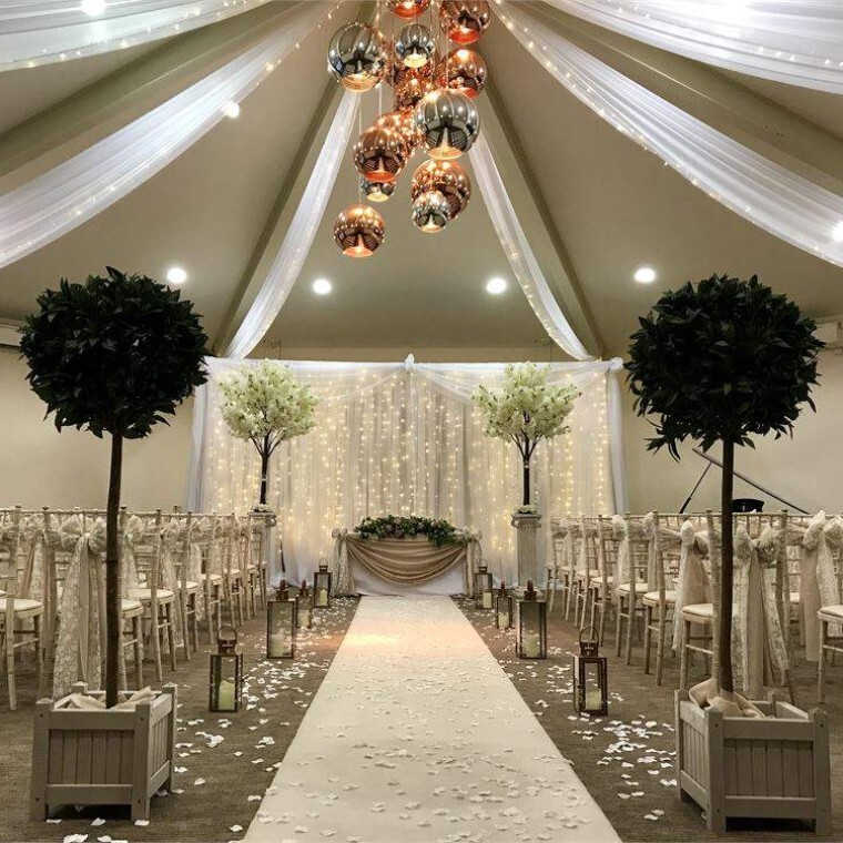 a white wedding in a fairylit room