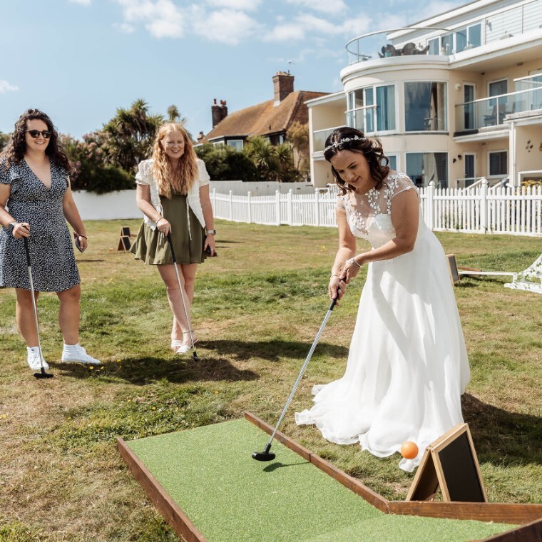 bride on their wedding day playing mobile mini golf