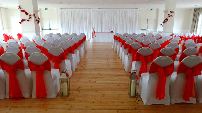 Red tie backs at Ravens Ait civil ceremony venue in Surrey