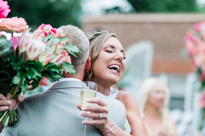Bride embracing guest at wedding in Hampton, London