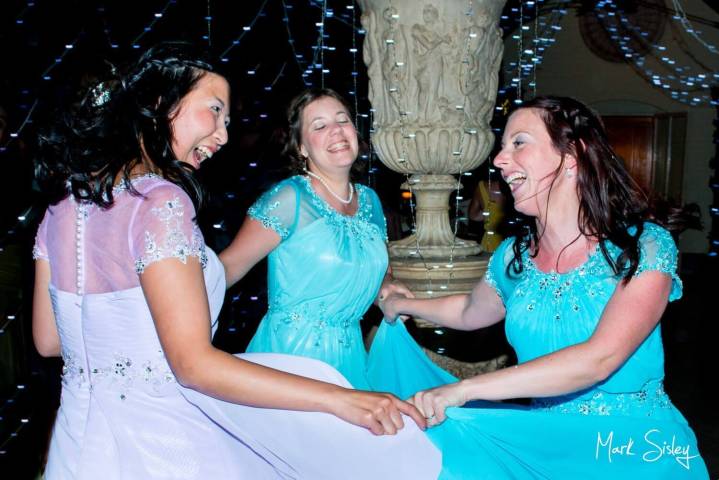 Bridesmaids enjoy the dancing at this wedding at The Dairy on The Waddesdon Estate