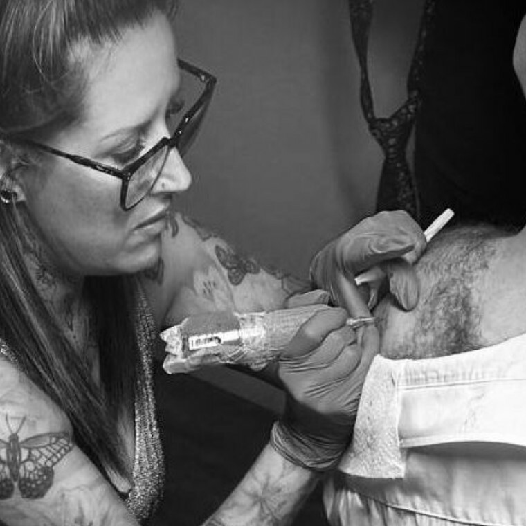 Ink2Bloom mobile tattoo artist working on a tattoo for a wedding guest