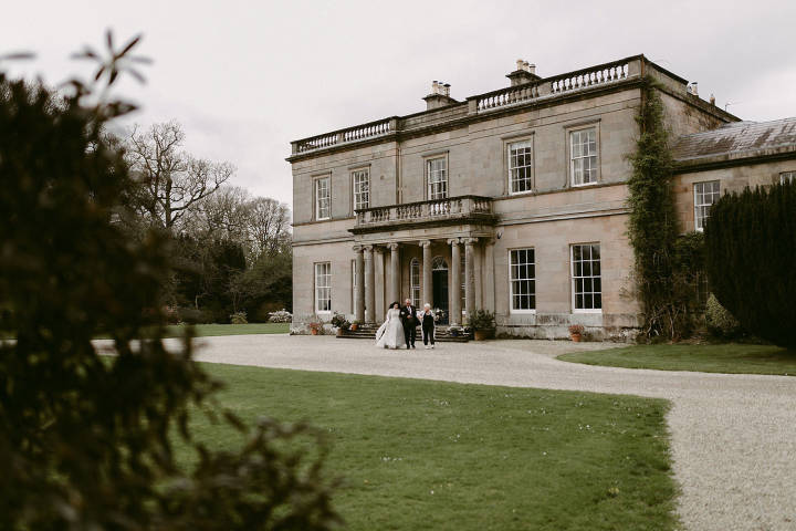 Couple in front of grand wedding venue