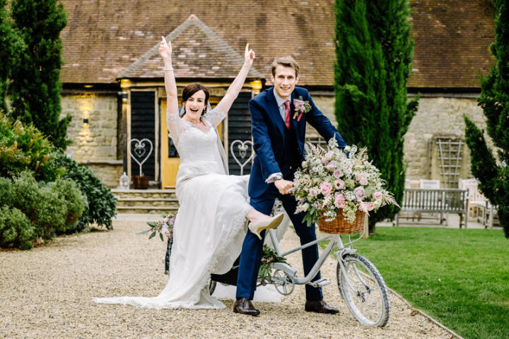 Bride and Broom on a bicycle at Notley Tythe Barn