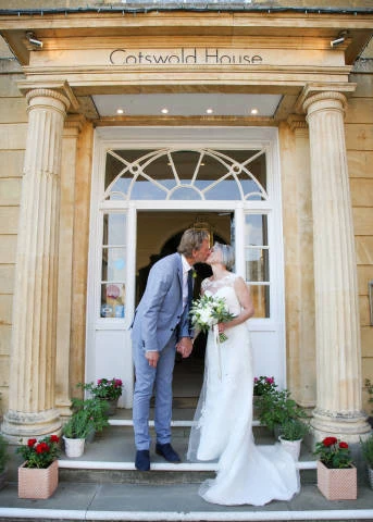 Kissing Couple Outside Door of Cotswold House Hotel and Spa, Venues in Chipping Campden, Gloucestershire