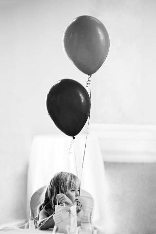 Flower girl with balloons at Danesfield House Wedding