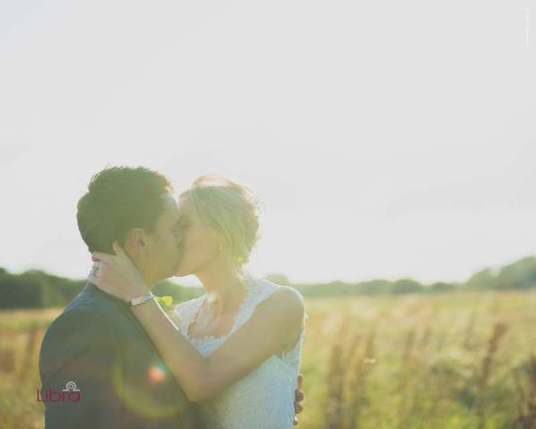 Summers meadow in dorset withthe couple kissing