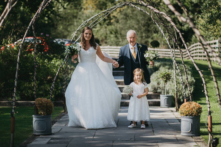 Bride, groom and bridesmaid in the garden at the Barns at Wick Farm Bath