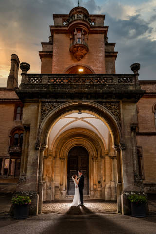 Evening View of Couple Standing In Archway of Grittleton House, Venues in Chippenham, Wiltshire
