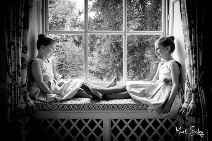 Flower girls pose for a window portrait at Hartwell House