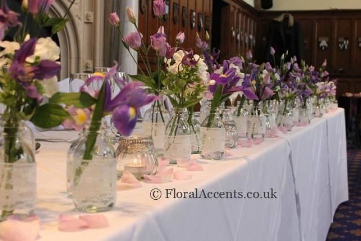 Vintage bottle top table floral design - by Floral Accents.
