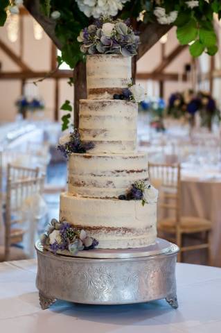 Vegan naked wedding cake with artificial flowers