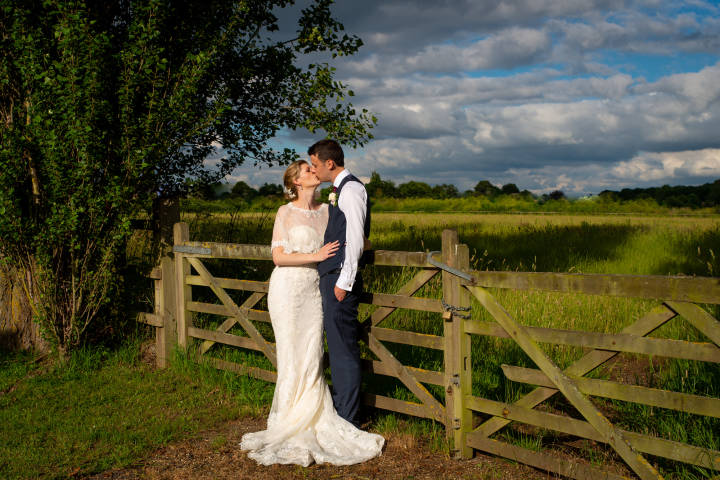 Stone Photos Wedding Photographer in Berkshire, Buckinghamshire, Surrey, Bride, Relaxed, natural, candid, Groom, Love, Couple, Portraits, kiss, field, 