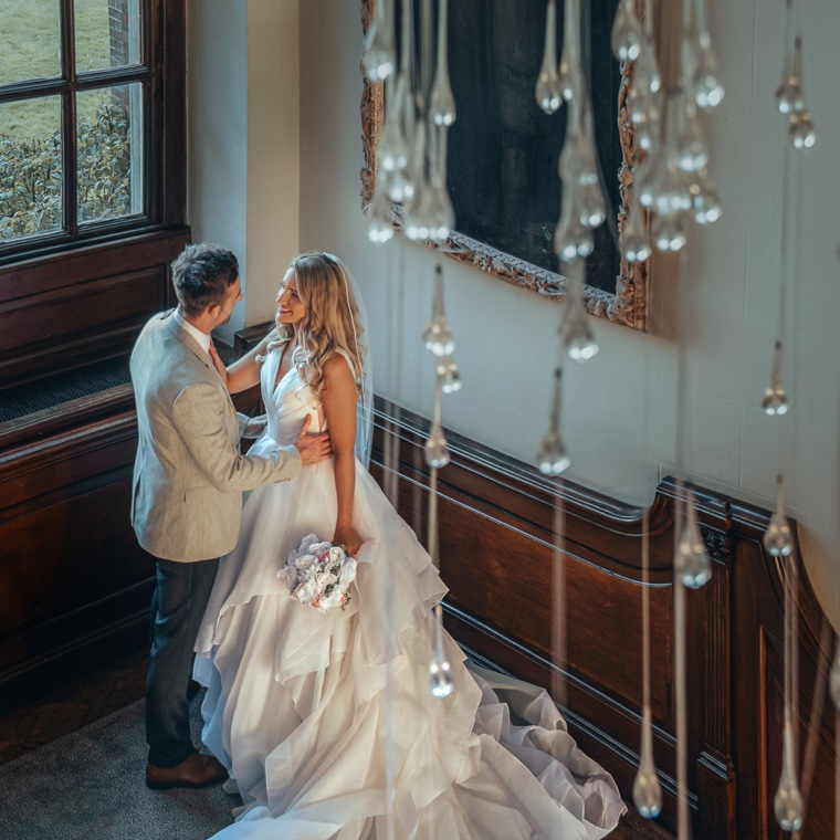 couple holding each other on staircase during their wedding