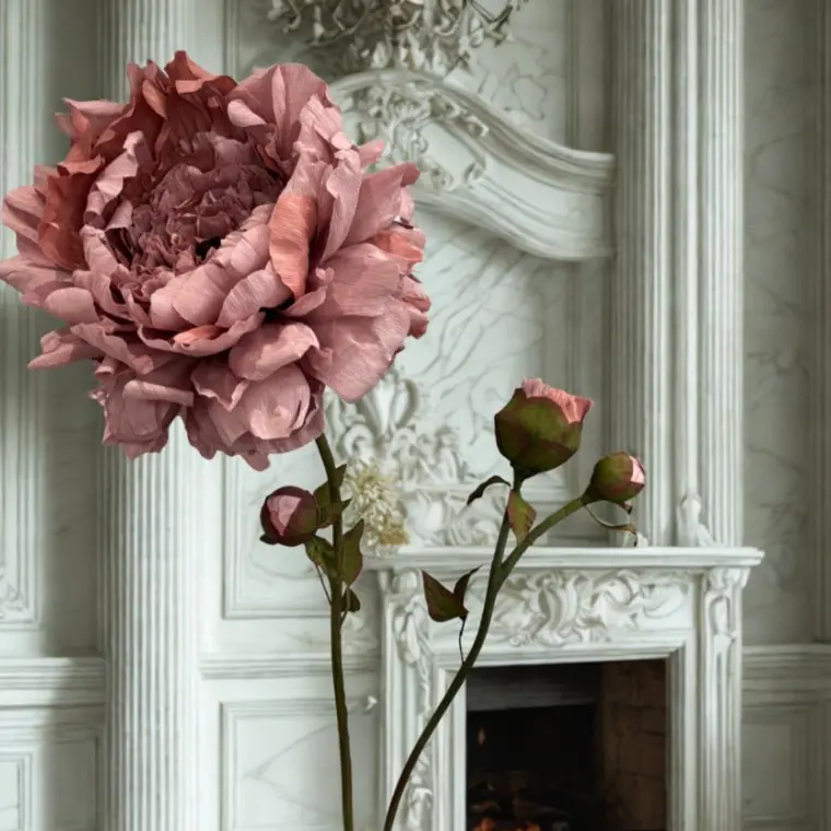 Large crepe paper Peony in front of the fireplace at a wedding venue by Capehorn Creative