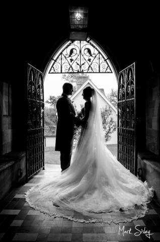 Dramatic silhouette portrait of bride & groom at their Buckinghamshire wedding