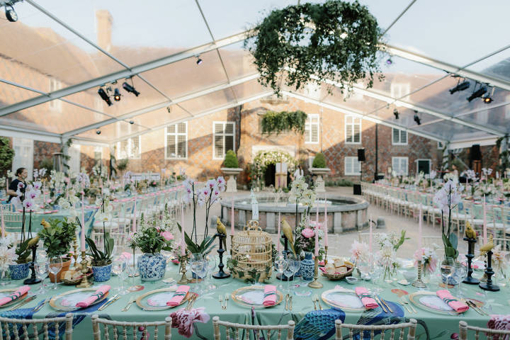 Glass marquee set up for wedding breakfast inside Fulham Palace courtyard
