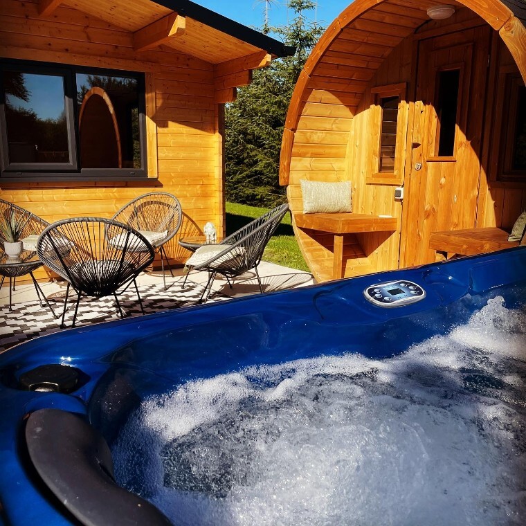 Shephard huts, outdoor chairs and hottub.