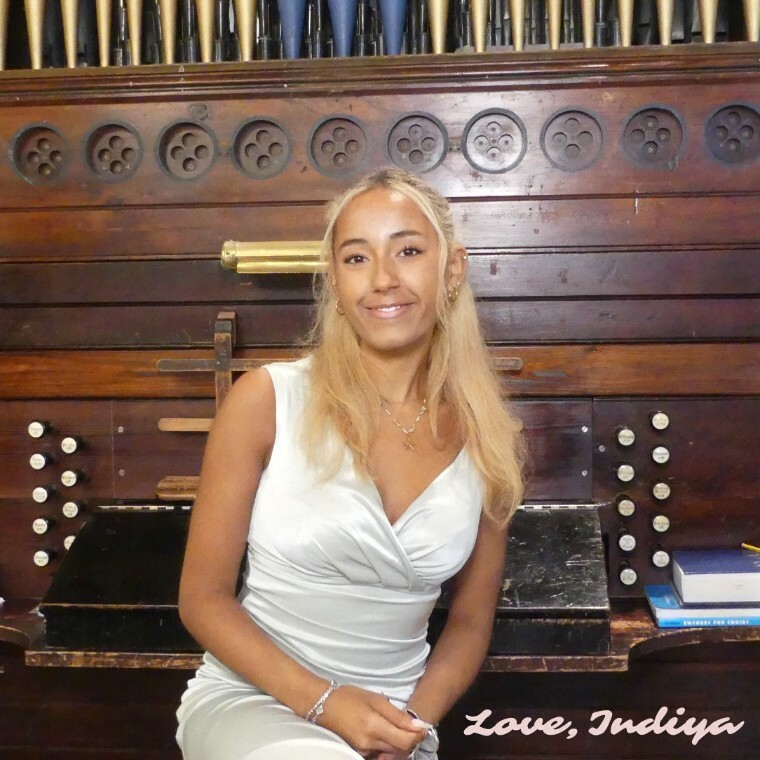 INDIYA sitting in front of a church organ, captioned, Love, Indiya
