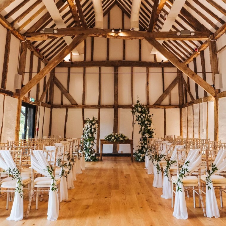 Ceremony setup with floral arch at Alfriston Gardens