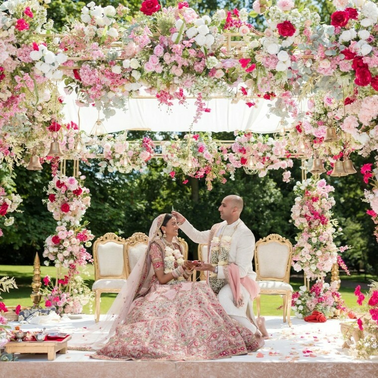 Couple surrounded by flower arches